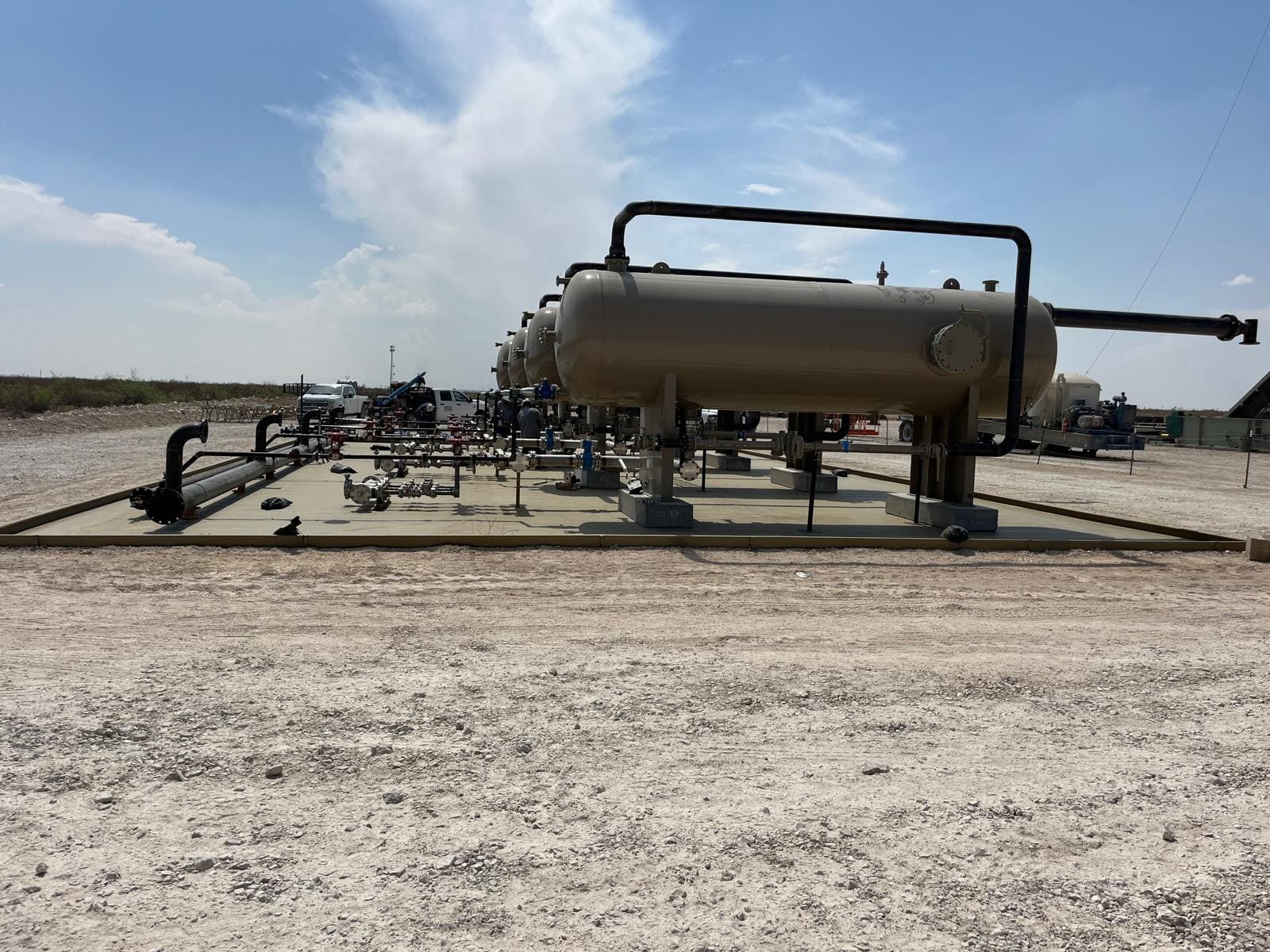 Vessel row and manifold with crew and work trucks on location